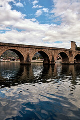 Fototapeta premium Bridge on river Drina, famous historic Ottoman architecture in Visegrad, Bosnia and Herzegovina.