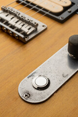 Killswitch button mounted on the control plate of an electric guitar
