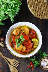 Kepiting Saos Padang or Indonesian Spicy crabs, served with shrimp and corn. Selective focus on dark wooden background.