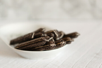 delicious sandwich with chocolate waffles in a plate on a table on a gray background. Creamy texture of waffle cookies. Waffle dessert.	