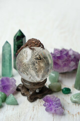 Minerals and toad on Magic crystal ball close up on rustic wooden table, abstract background....