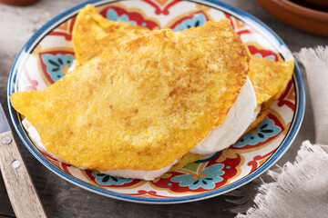 Traditional Venezuelan beef cachapa on wooden table