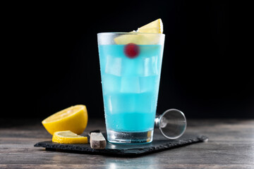 Deep blue sea martini cocktail on wooden table