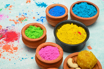 top view of colorful traditional holi powder in bowls isolated on dark background.Space for text . happy holi.Concept Indian color festival called Holi