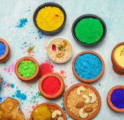 top view of colorful traditional holi powder in bowls isolated on dark background.Space for text . happy holi.Concept Indian color festival called Holi