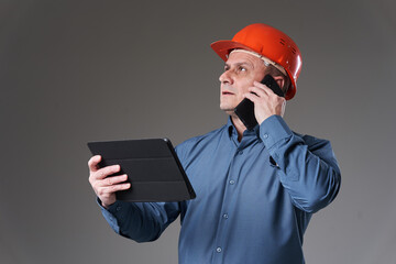 Engineer with tablet and mobile phone