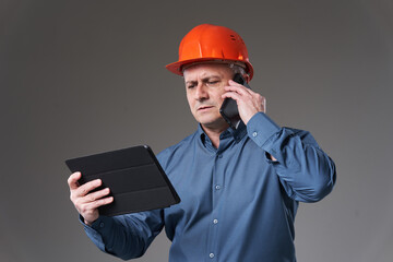 Engineer with tablet and mobile phone