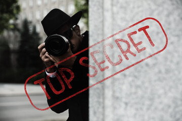 Classified information. Private detective with camera investigating on city street. Stamp Top Secret