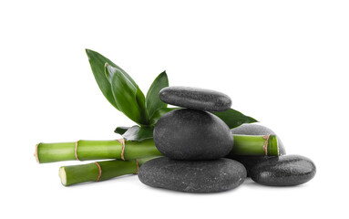 Spa stones with green bamboo stems isolated on white