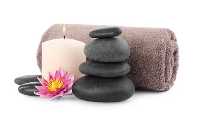 Fototapeta na wymiar Stack of spa stones, towel, flower and candle isolated on white