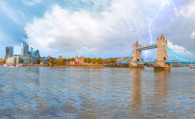 Panorama of the Tower Bridge and Tower of London on Thames river at twilight blue hour with thunder and lightning - London England