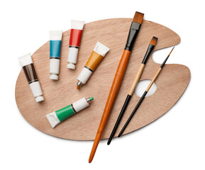 Wooden palette with oil paints and brushes on white background, top view