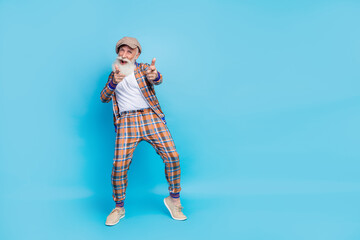 Full length photo of funky senior showman stylish vintage suit hand point you invite join empty space isolated on blue color background