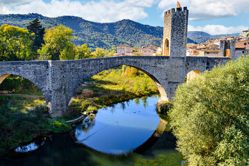 Famous medieval bridge over the river Fluvia in the medieval village de Besalú, Girona, Catalonia,...