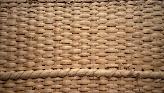 Photo of the texture of a wicker basket. Weaving of dry reeds. Natural furniture for the terrace made of dry grass.