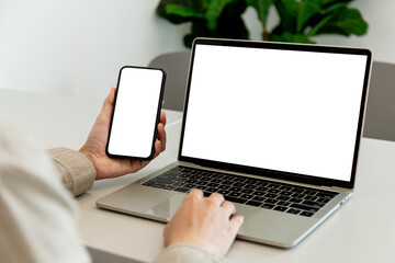 computer screen,cell phone blank mockup.hand woman work using laptop texting mobile.white background for advertising,contact business search information on desk in cafe.marketing,design