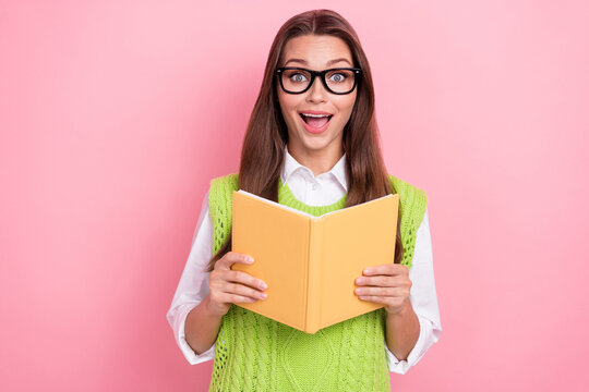 Photo of young funky excited overjoyed student lady reader new non fiction stories book wear green cardigan shock isolated on pink color background