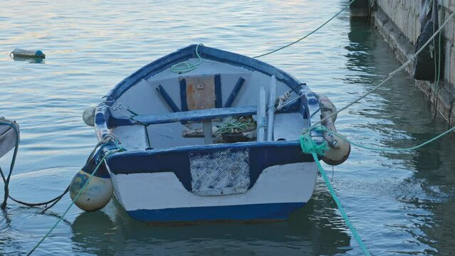 boat in the water at the harbor fixed with buoys and ropes