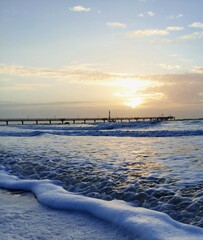 winter sunset over the baltic sea with a seabridge on the background