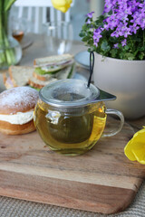 Enjoy a Delicious Brunch with a Perfect Cup of Tea - Beautifully Strained and Served in a Glass Teacup - Surrounded by a Bounty of Fresh and Flavorful Food Options