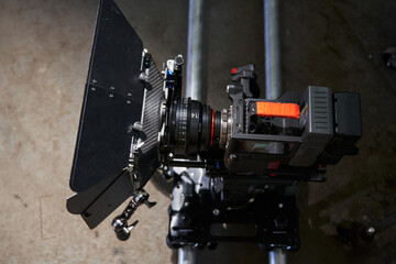 top view of a professional film camera, which stands on camera rails. camcorder with a professional cine lens and body kit.