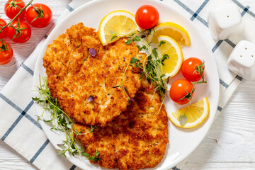 fried breaded chicken breast cutlets on plate