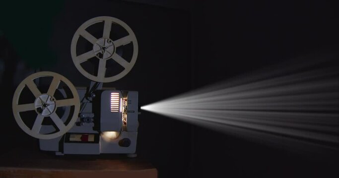 Vintage movie projector playing a film.