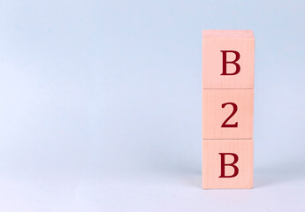B2B on wooden cubes on a blue background