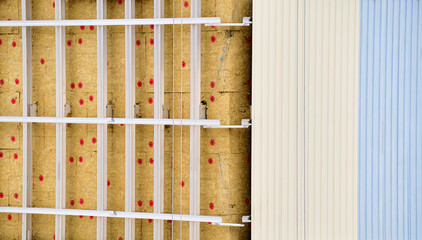 Repair and renovation of facade wall of multi-storey building with mineral insulation and metal profile. Heat saving concept.
