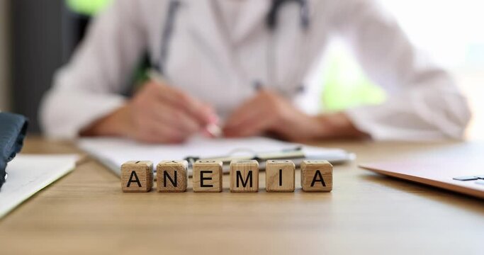 Doctor writes diagnosis of anemia in medical documents