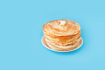 Staple of yeast fluffy pancakes with butter. Spring holiday Traditional Russian Shrovetide Maslenitsa week or pancake tuesday holiday. american crepes isolated on white gray background. side view