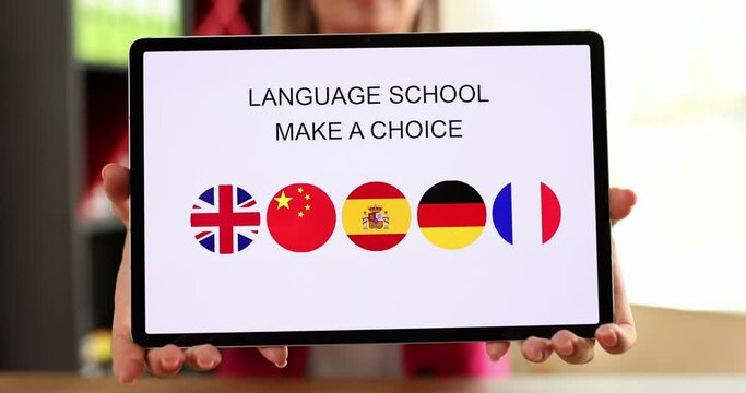 Hands holding tablet with language school application