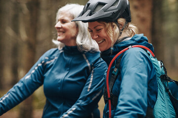 Laughing daughter and mother out for a mountain bike ride