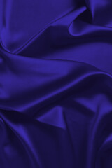 Rich and luxury red silk fabric texture background.