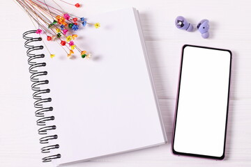 Smartphone and paper notebook mockup with flowers