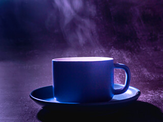 blue coffee mug on the old wooden floor in the black background,