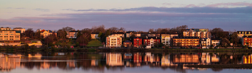 Houses on a street in Galway, Ireland are reflected on the surface