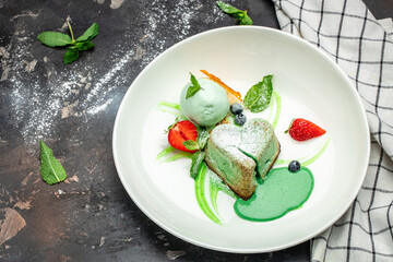 pistachio fondant dessert on a dark background, banner, menu, recipe place for text, top view