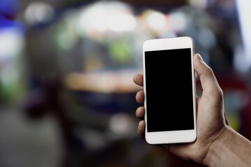 Hands hold a phone with a blank screen