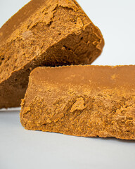 brown cheese,Norwegian brunost isolated on white background, Healthy food and eating, organic ingredient for breakfast, Traditional Scandinavian brown cheese, flat lay, mockup, 