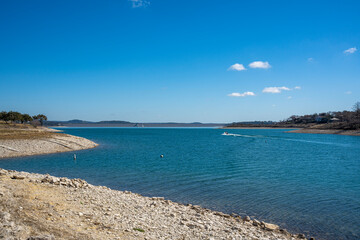 Lake with blue sky small boat in distance