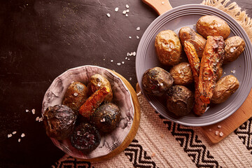 Healthy vegetables - baked potatoes, carrots, beetroot on rustic background. Whole food diet, Mediterranean diet.