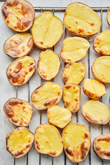 Potato wedges, oven roasted, a close-up in a baking tray. Home cooking. Healthy food, cooked without oil and salt.