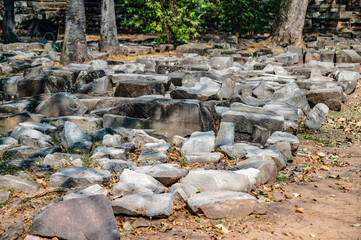 The carved images on the sandstone blocks laying on the floor awaiting restoration at Prasat Hin Phimai. Ancient Khmer castle at Nakhon Ratchasima, Thailand