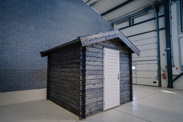 New pinewood shed on factory. black painted storage hut.