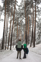 Kids walking in the forest with a backpack