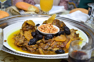 Moroccan dish with meat, plums ans sesameseeds close up.