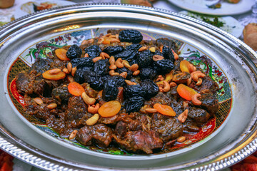 Moroccan dish with meat, plums ans sesameseeds close up.