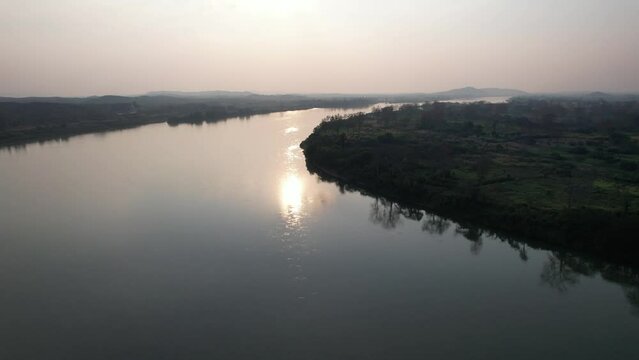 Aerial view of the city by the Mekong river before sunset by drone