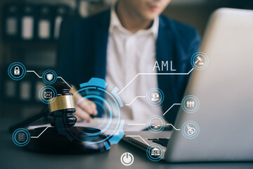 Judge in a courtroom using laptop and tablet with AML anti money laundering icon on virtual  screen.